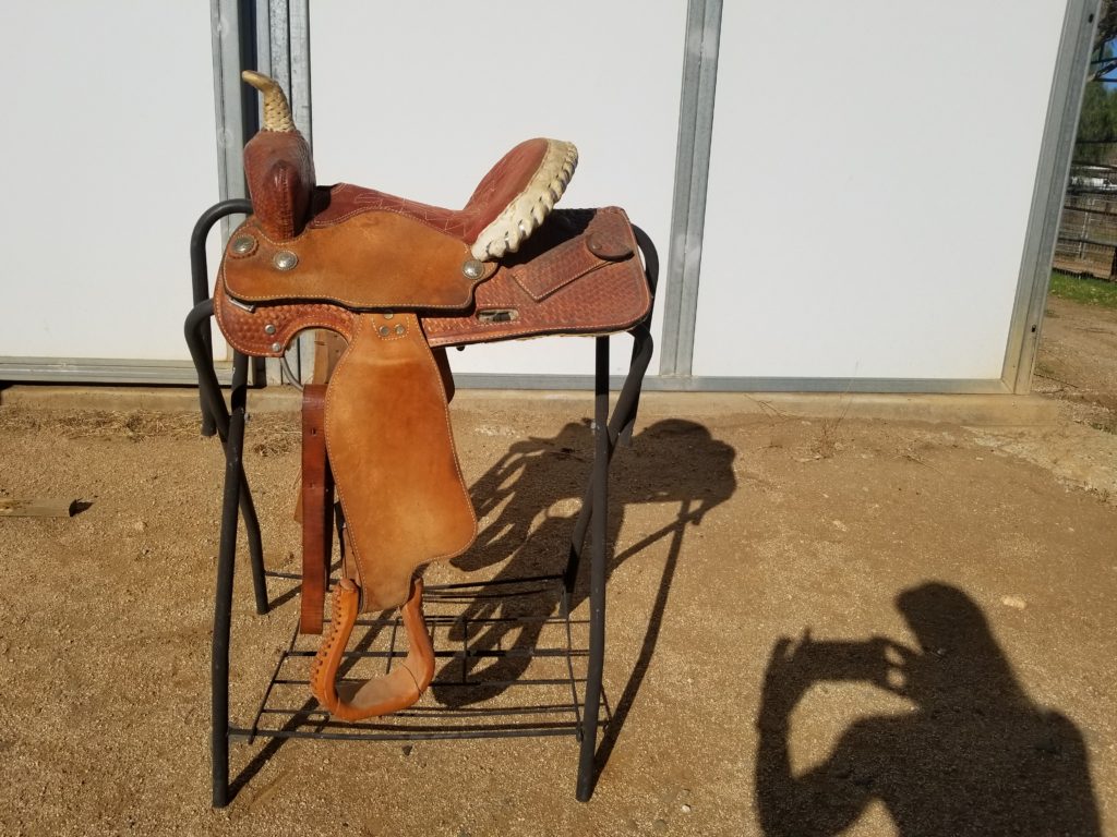 A horse head sculpture on top of a metal stand.