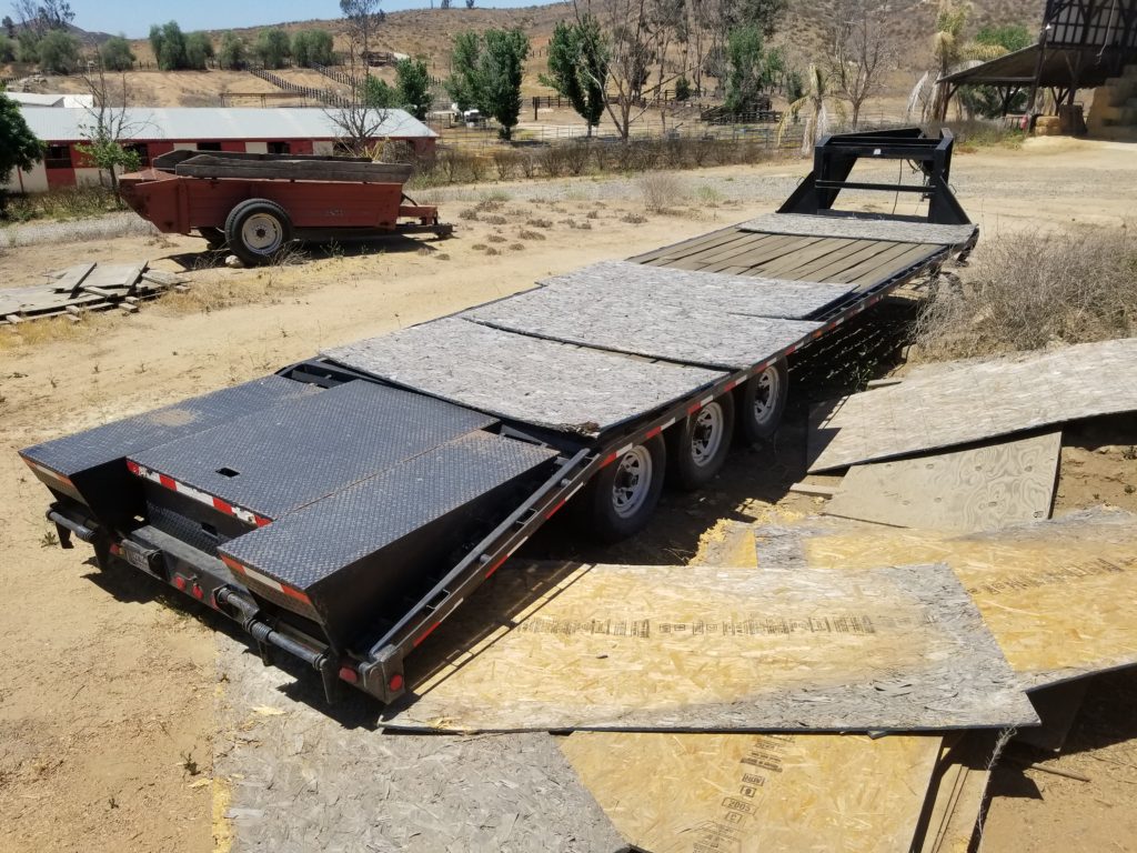 A large trailer is parked on the ground.